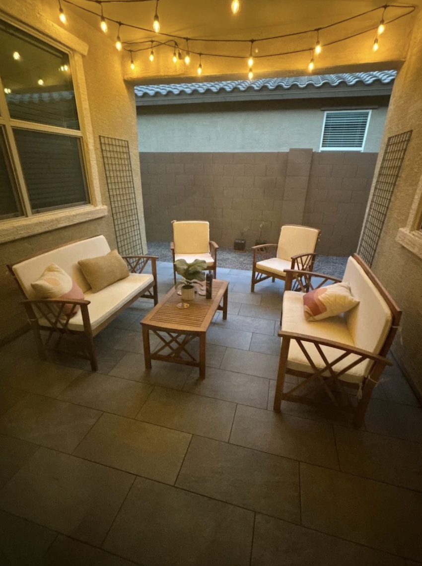 Paver patio courtyard with seating and string lights at dusk